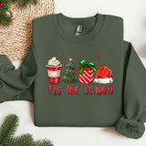 a green sweater with a cup of coffee and a christmas tree