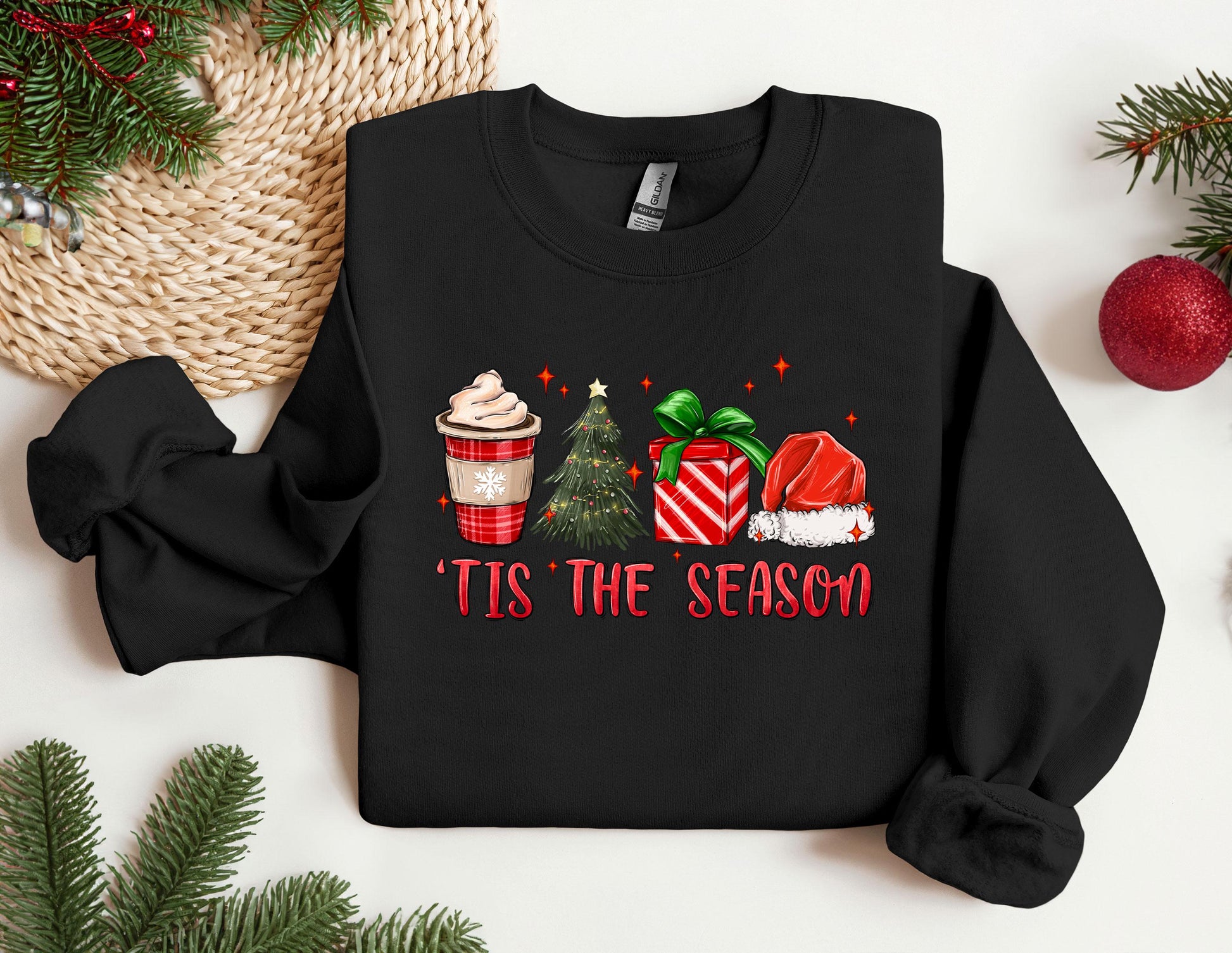 a black shirt with a christmas sweater and a cup of coffee