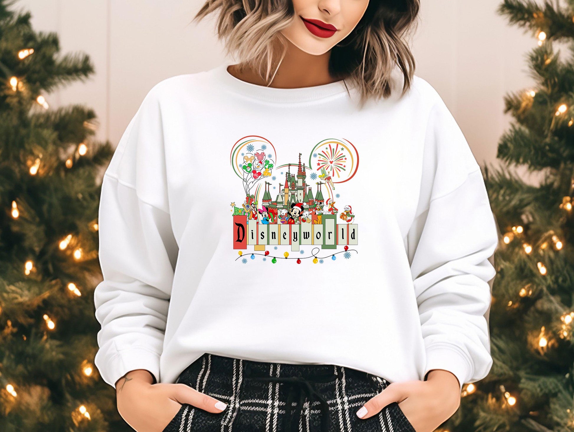 a woman standing in front of a christmas tree