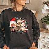 a woman sitting on a bed wearing a black sweatshirt