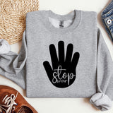 a gray sweatshirt with a black stop sign on it