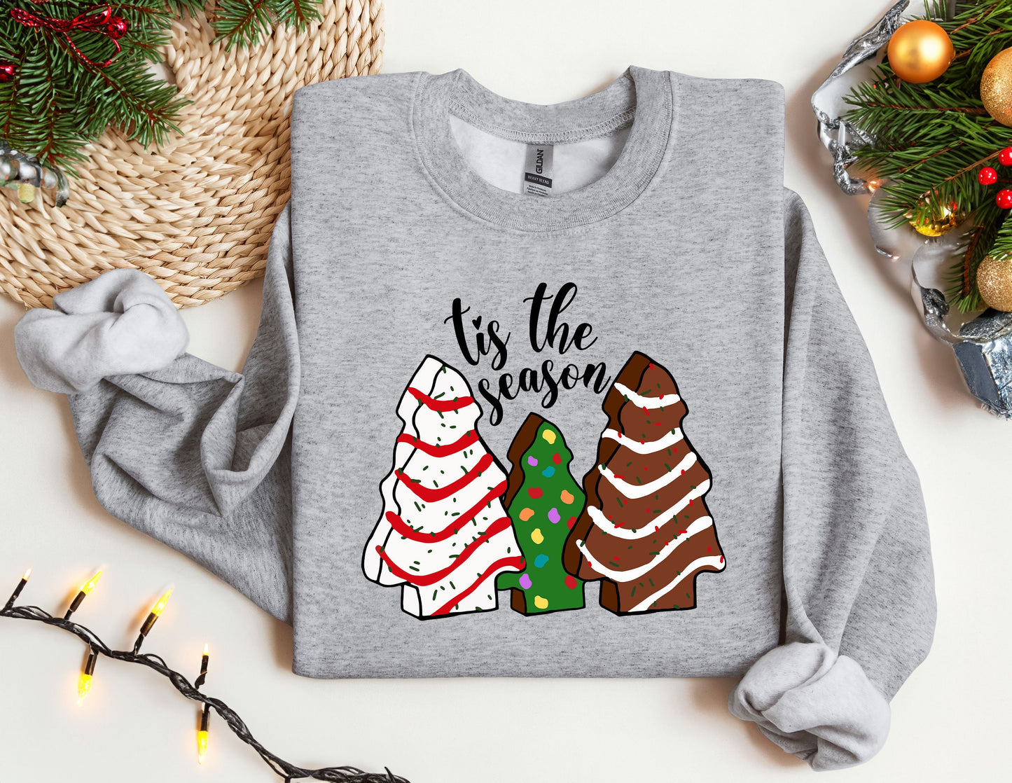 a sweater with a christmas tree and three trees on it