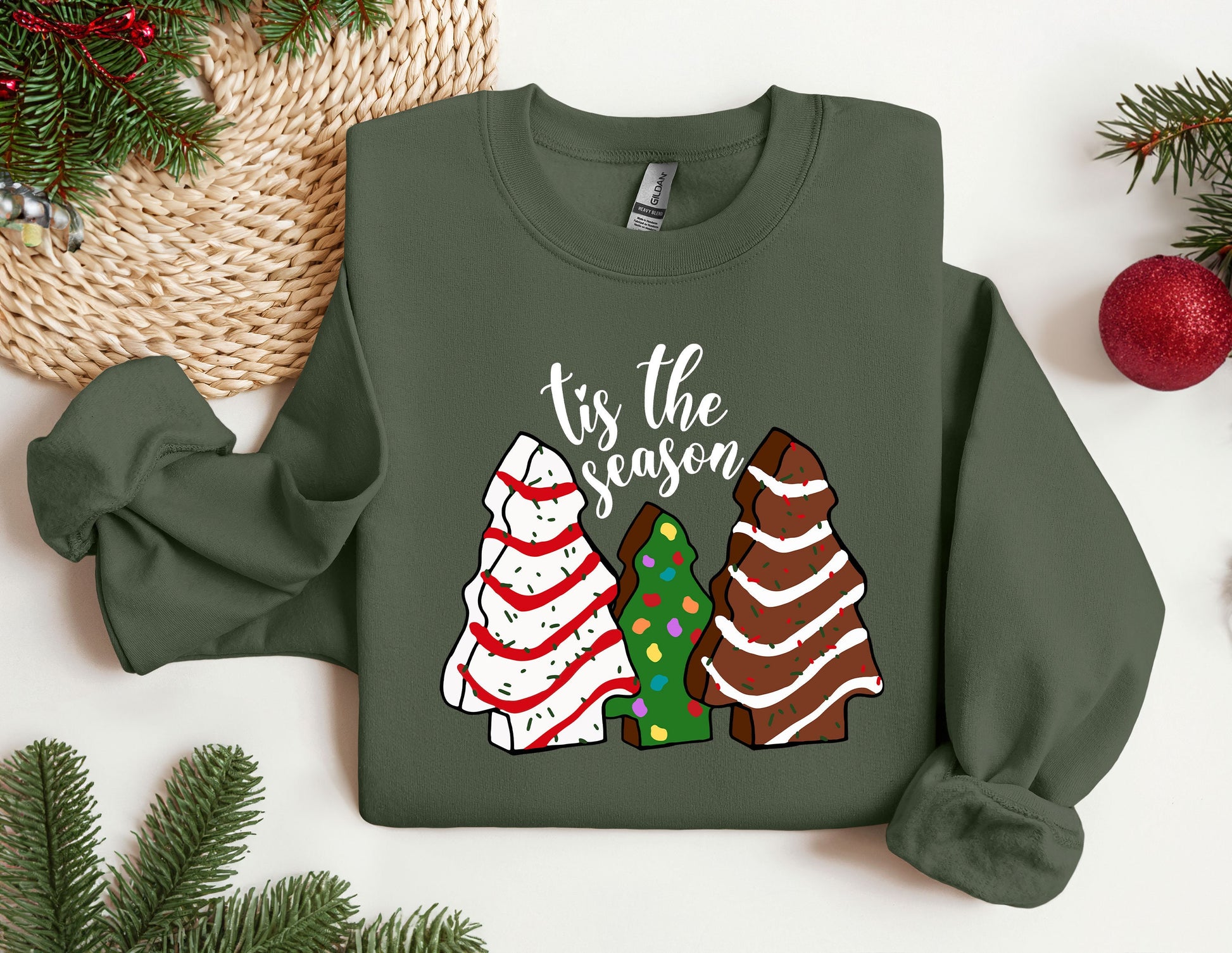 a green sweater with a christmas tree and three sweaters on it