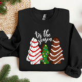 a black shirt with a christmas tree and three sweaters on it