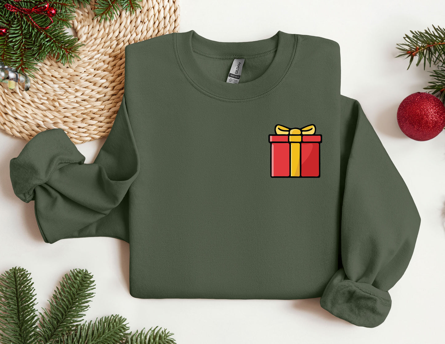 a green sweater with a red and yellow gift box on it