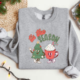 a sweater with a christmas tree and a cupcake on it