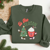 a green sweatshirt with a christmas tree and a cupcake on it