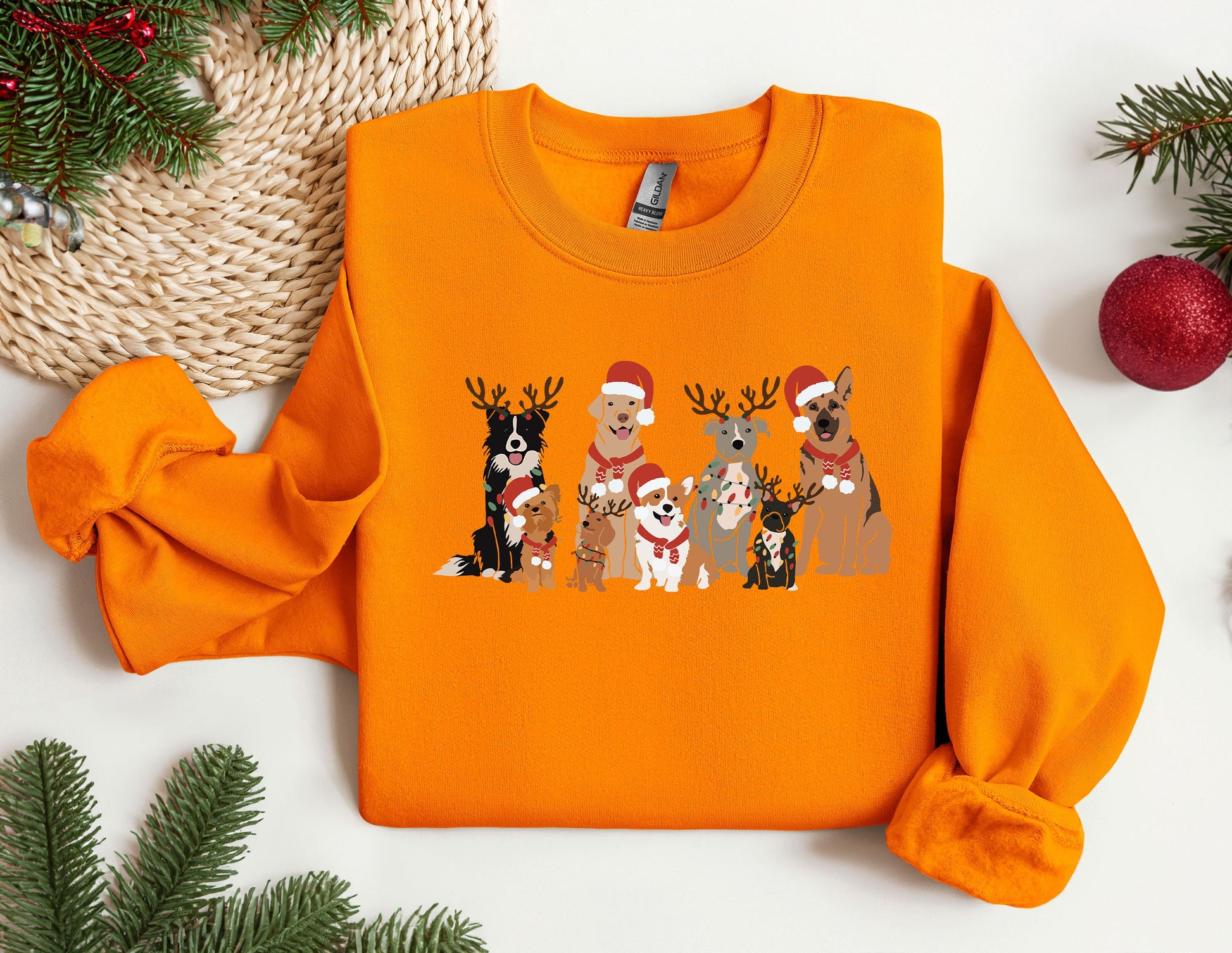 a group of dogs wearing santa hats on an orange sweater