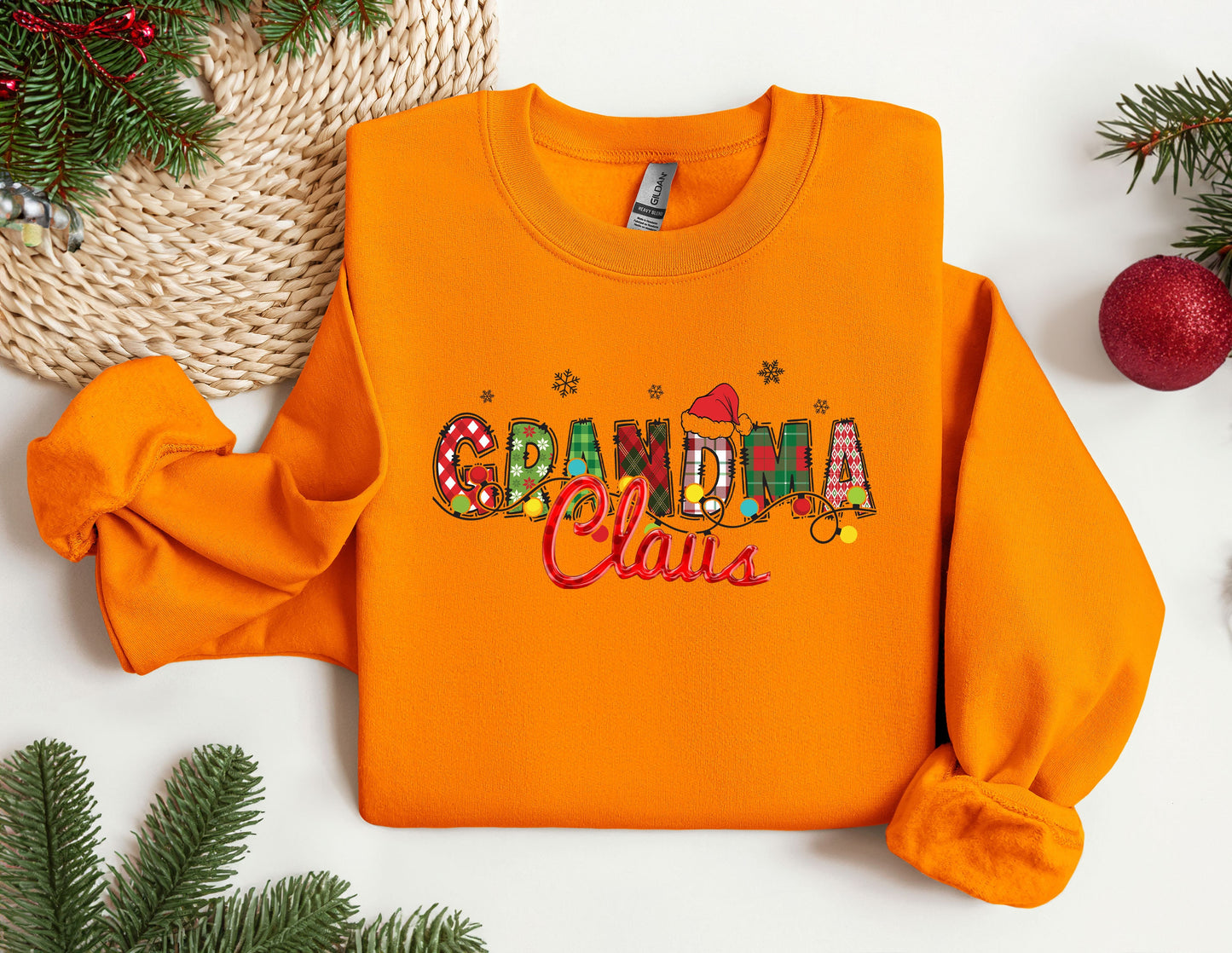 an orange sweatshirt with the word grandma claus on it