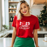 a woman standing in a kitchen wearing a red t - shirt