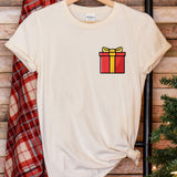 a t - shirt with a present on it next to a christmas tree