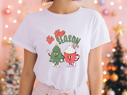 a woman wearing a white t - shirt with a christmas tree on it