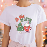 a woman wearing a white t - shirt with a christmas tree on it