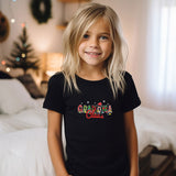 a little girl that is standing in front of a bed
