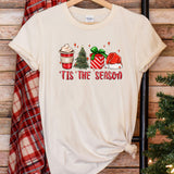 a t - shirt that says tis the season next to a christmas tree