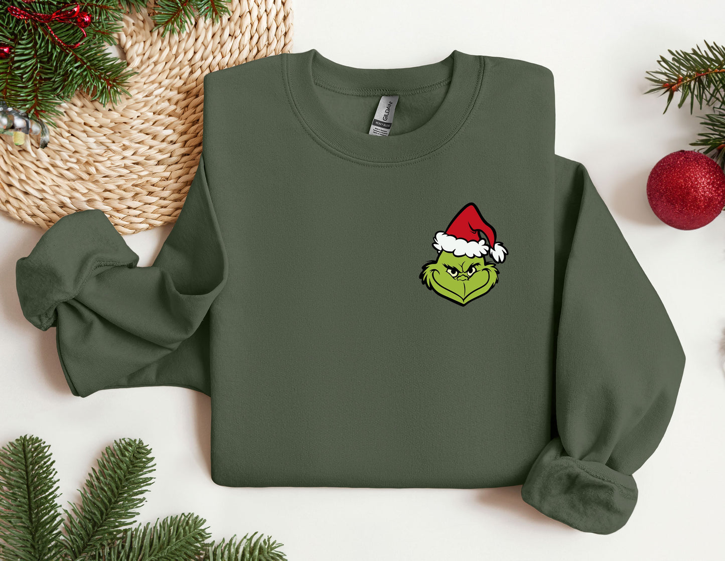 a green sweatshirt with a christmas hat on it