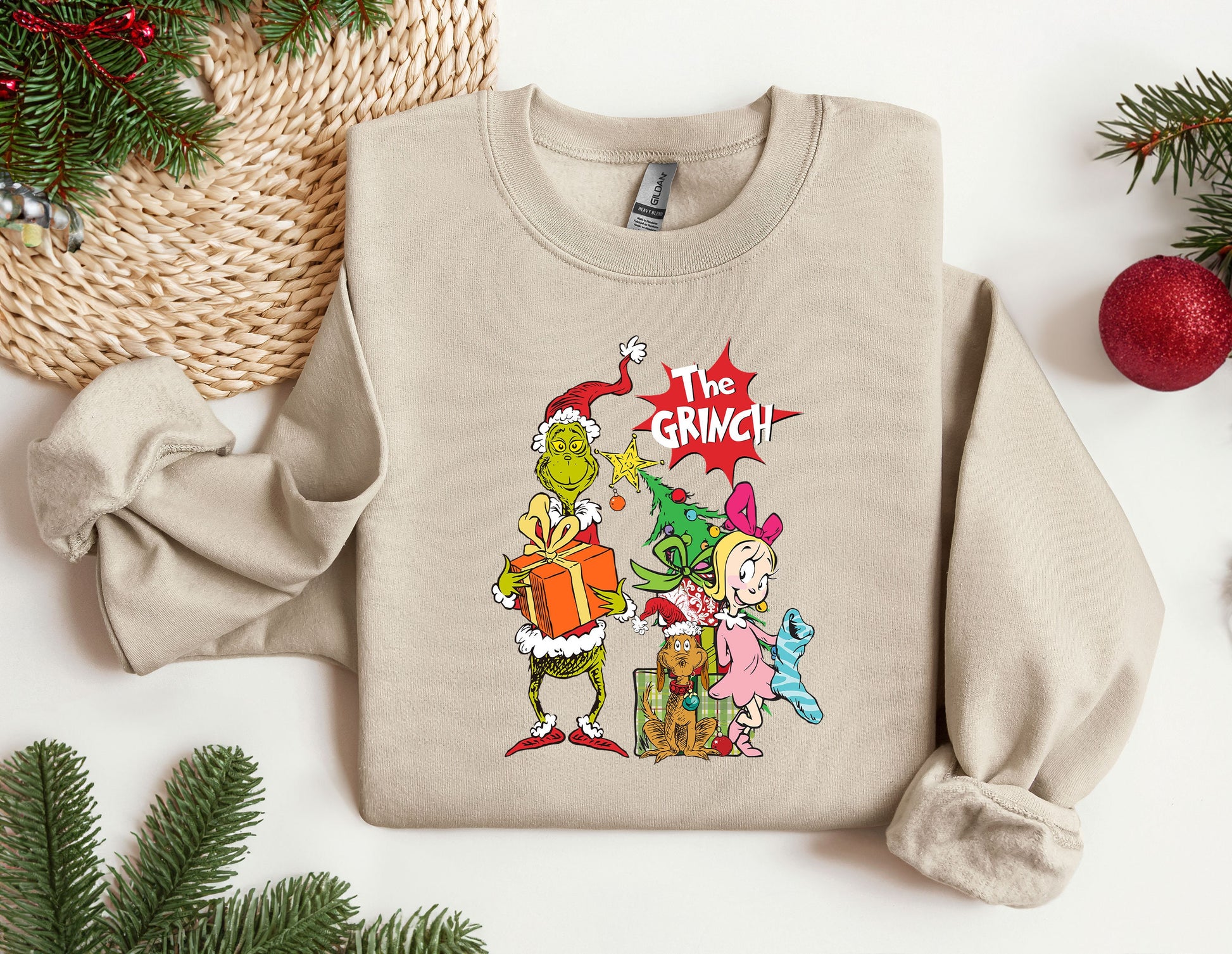 a sweater with the grinch characters on it