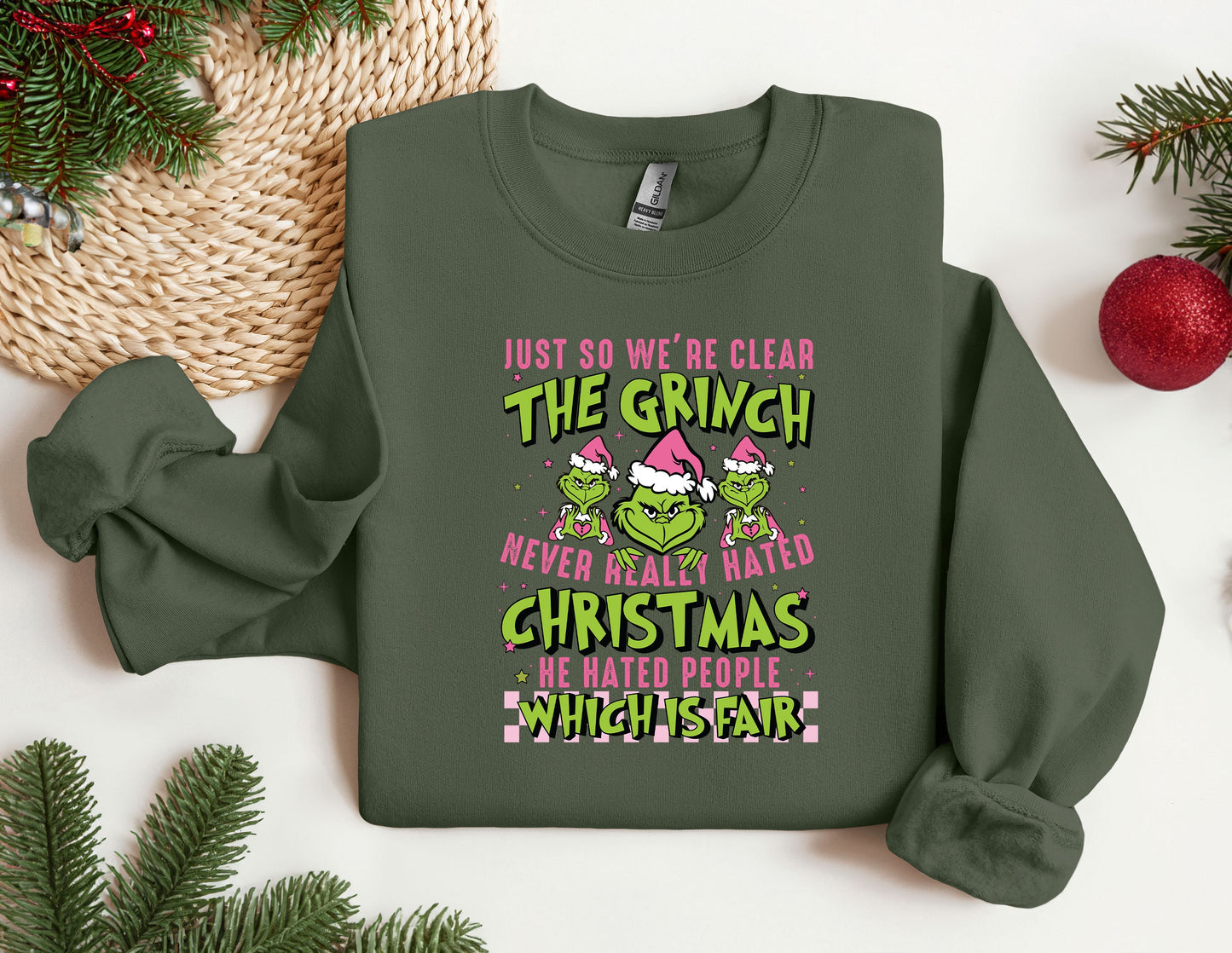 a green christmas sweater with the grin on it