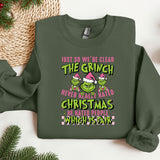 a green christmas sweater with the grin on it