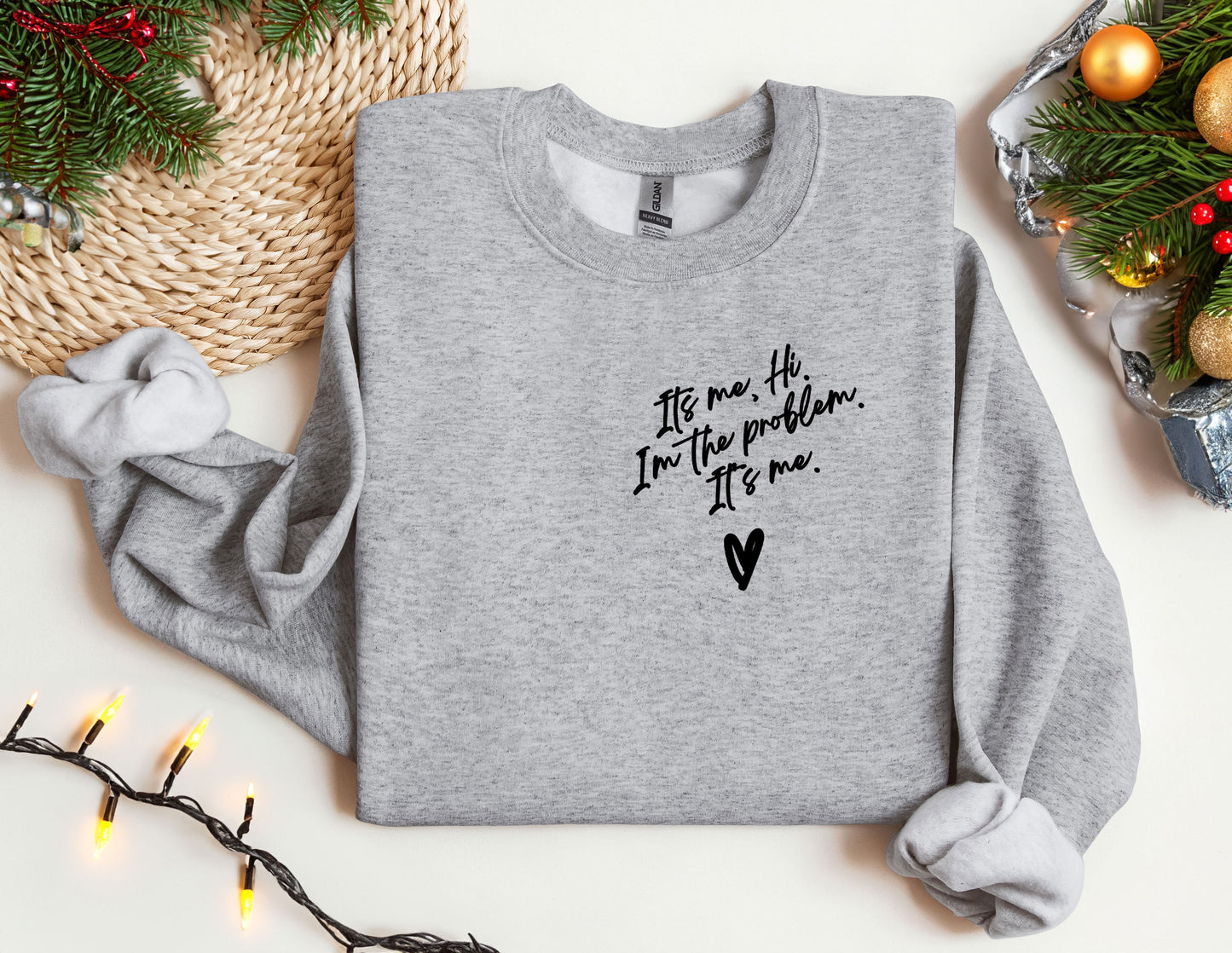 a sweater with a message on it next to a christmas tree