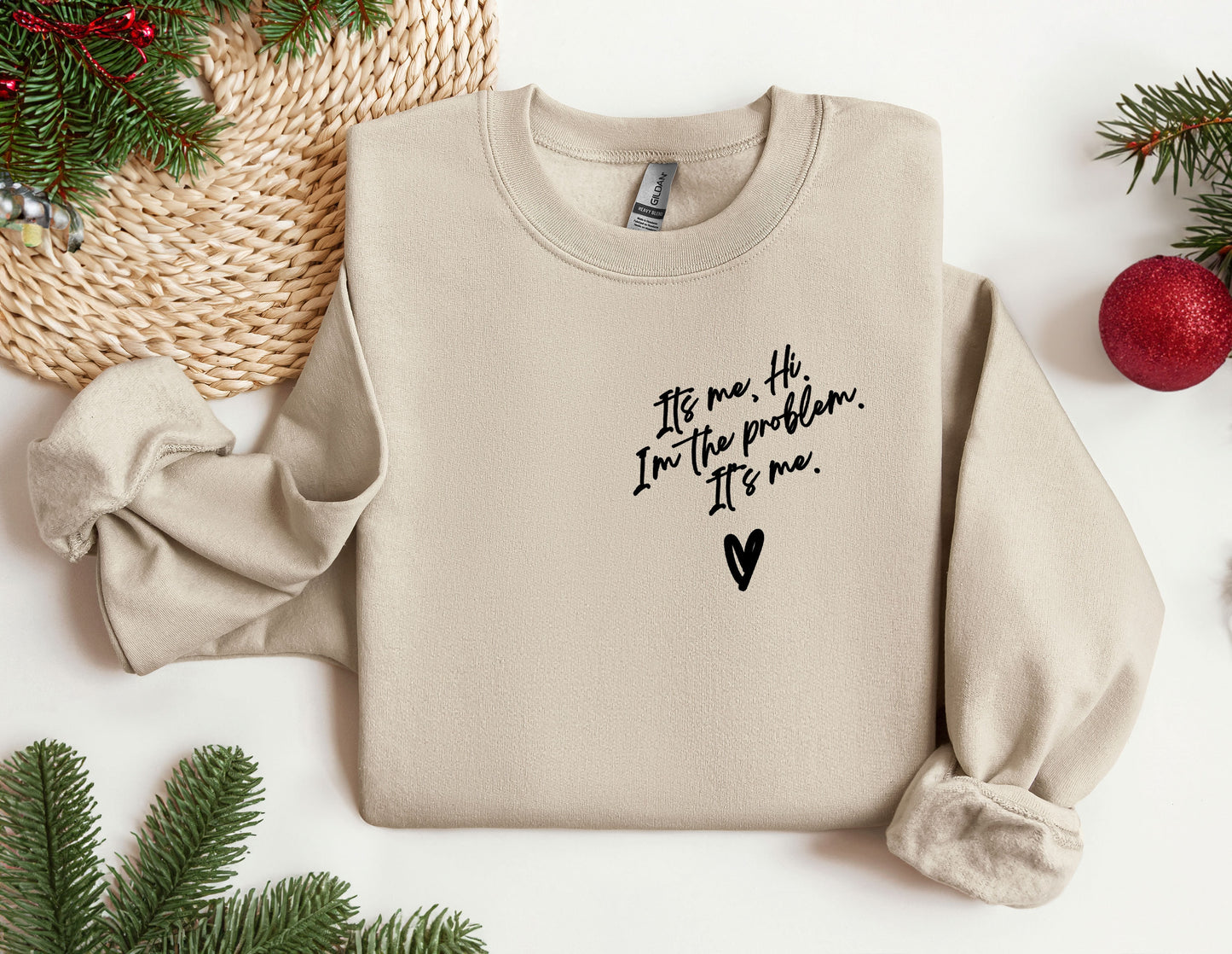 a sweater with a message on it next to christmas decorations