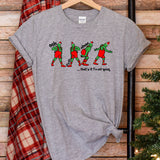 a t - shirt with a picture of two people walking down the street