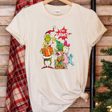 a white t - shirt with the grin on it next to a christmas tree
