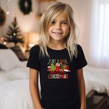 a little girl that is standing in front of a bed