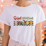 a woman wearing a t - shirt that says sweet christmas
