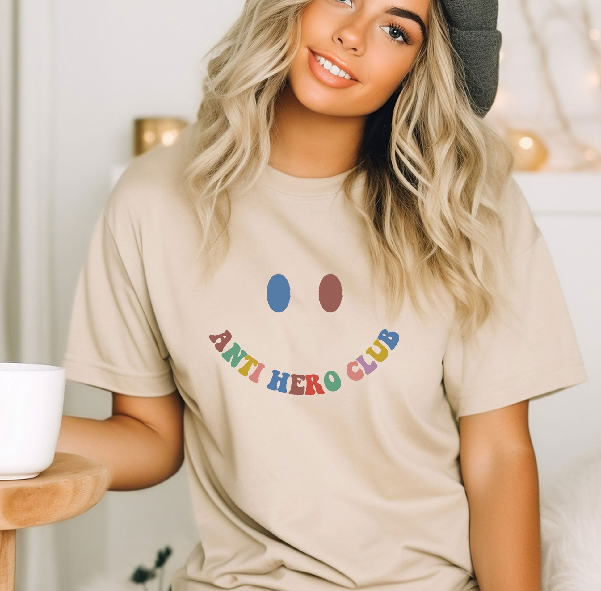 a woman sitting on a bed with a cup of coffee