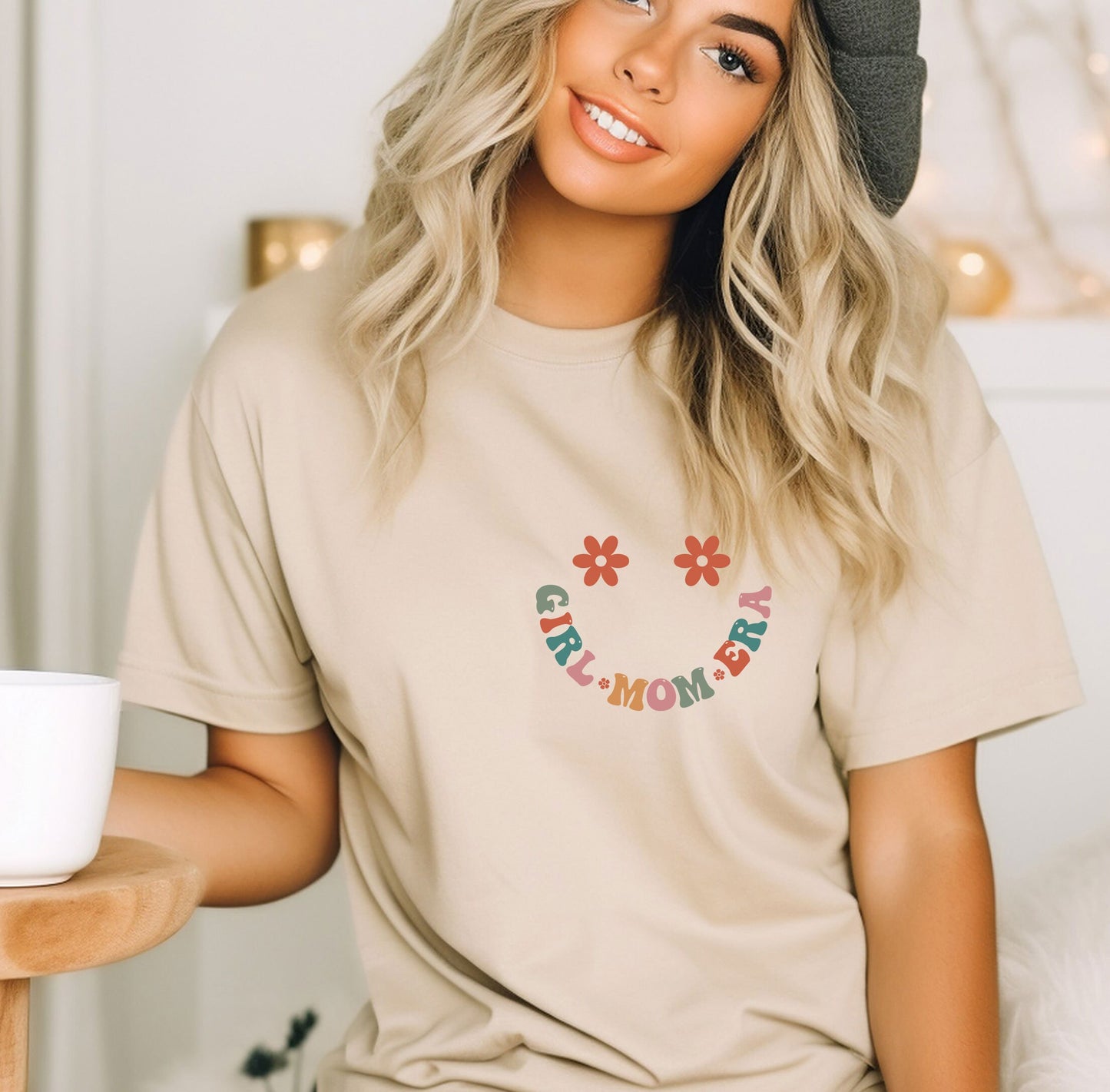 a woman sitting on a bed with a cup of coffee