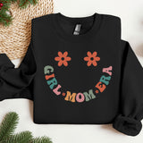 a black sweatshirt with a smile drawn on it