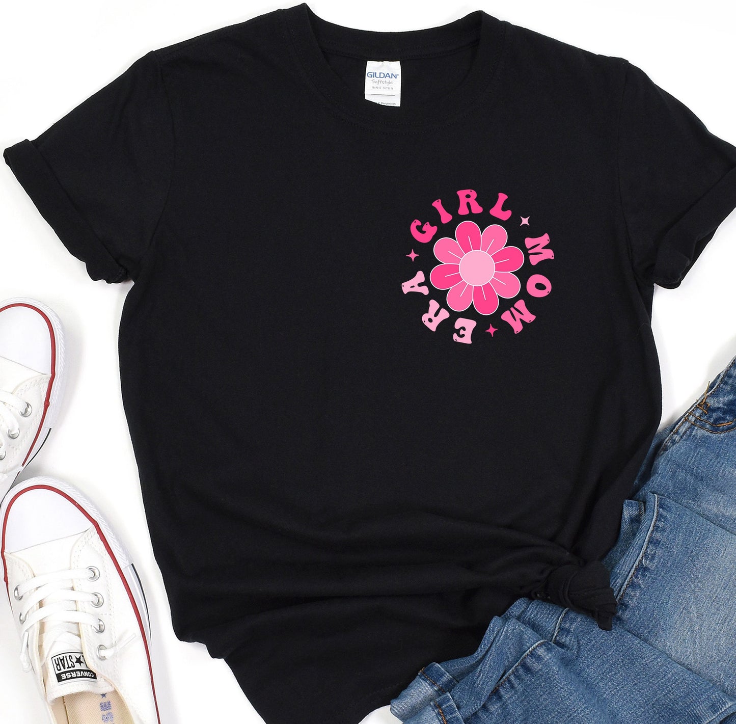 a black shirt with a pink flower on it