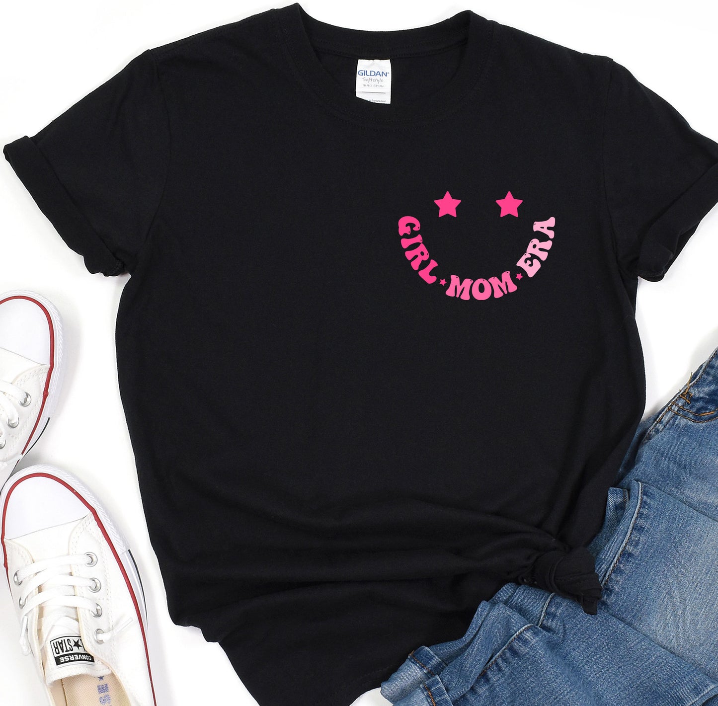 a black shirt with pink stars and a smiley face