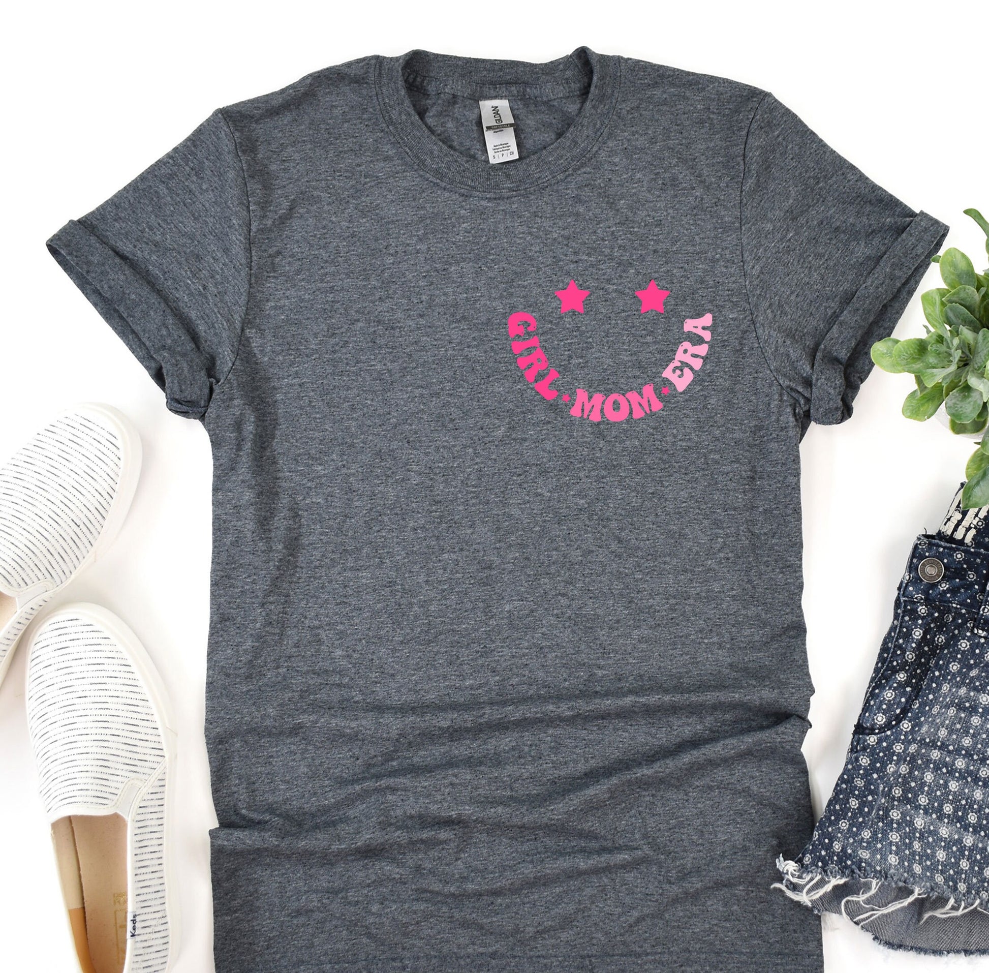 a women&#39;s t - shirt with the word mom on it next to a