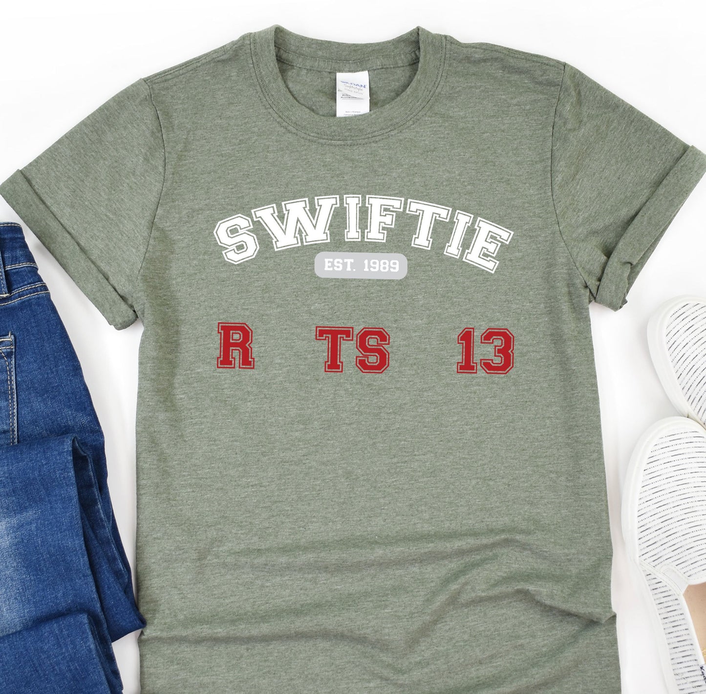 a t - shirt with the words swiffie on it next to a pair