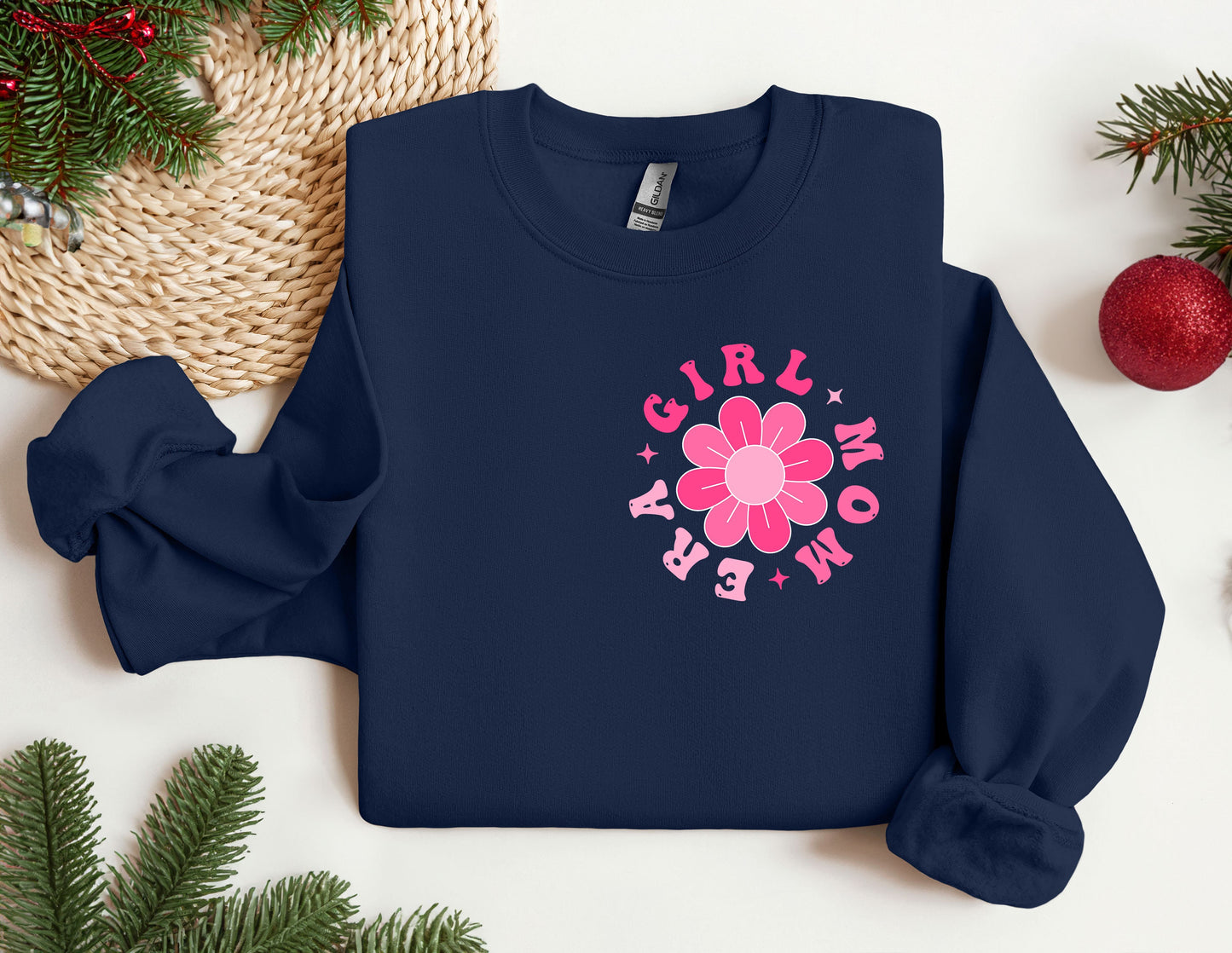 a blue sweatshirt with a pink flower on it