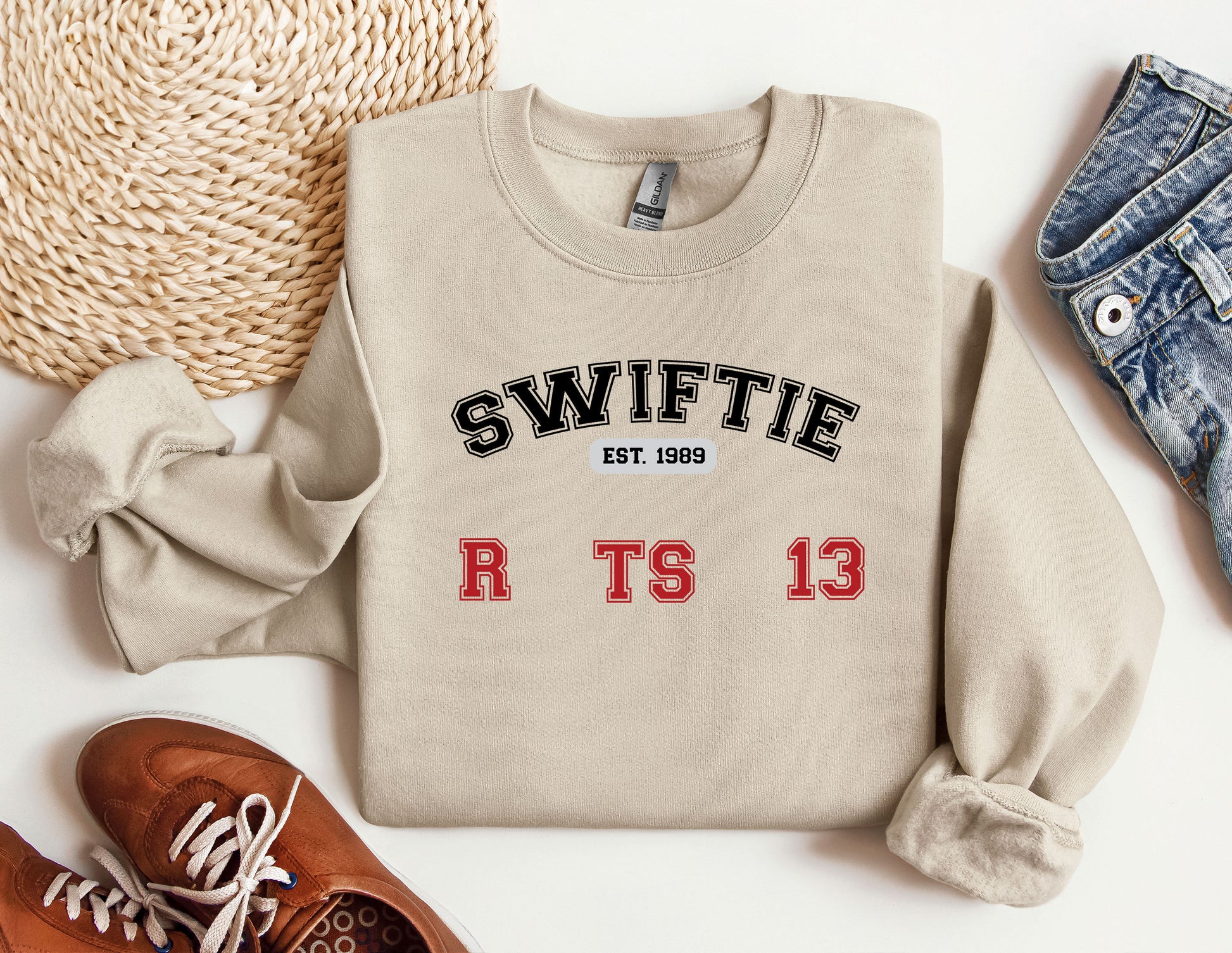 a sweater with the words swiffie on it next to a pair of shoes