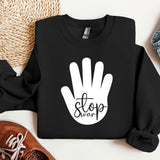 a black sweatshirt with a white stop sign on it