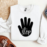 a white sweatshirt with a black stop sign on it