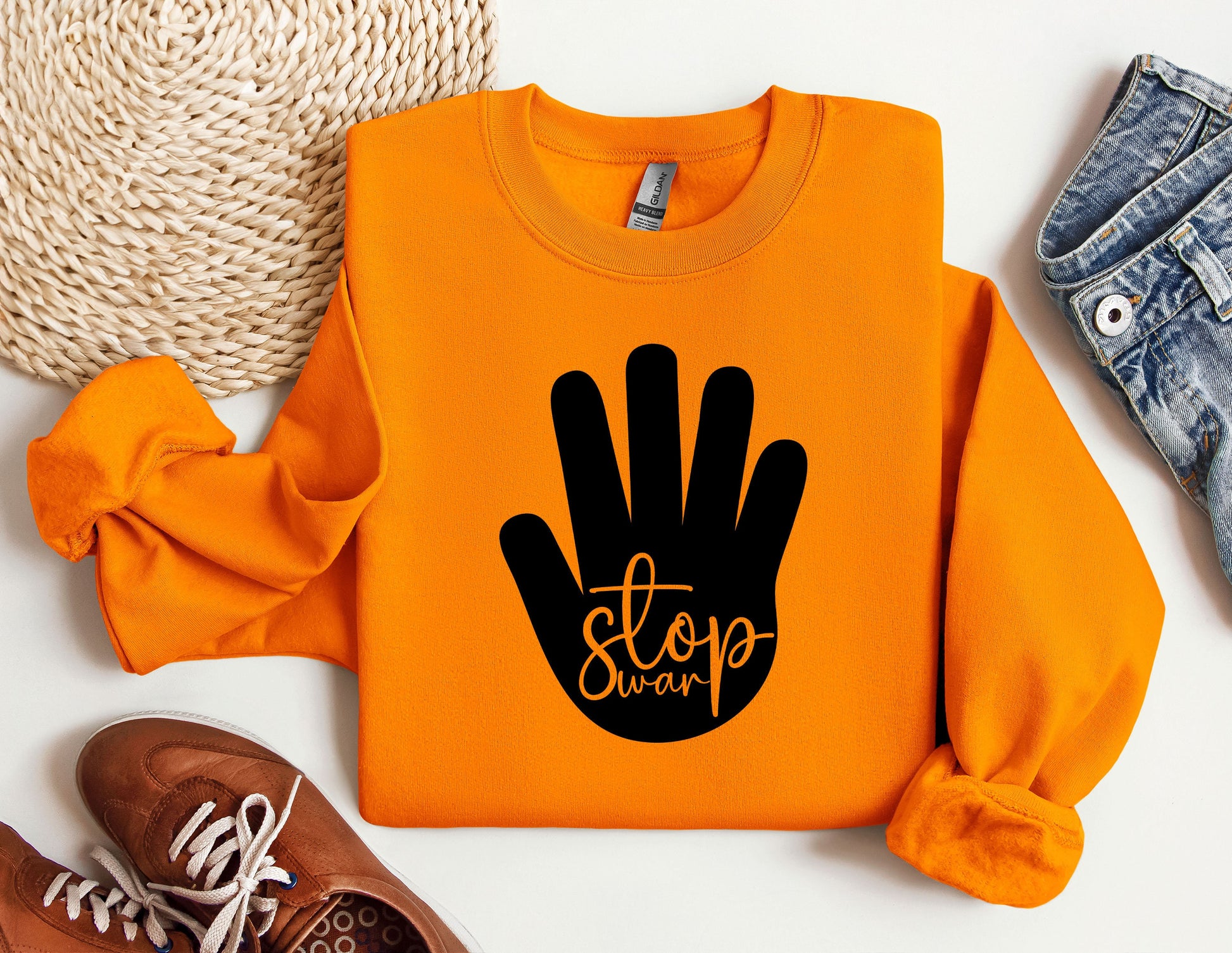 an orange sweatshirt with a black stop sign on it