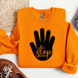 an orange sweatshirt with a black stop sign on it