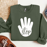 a green sweatshirt with a white stop sign on it