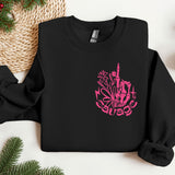 a black sweatshirt with a pink design on it