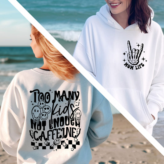 two women wearing matching sweatshirts on the beach