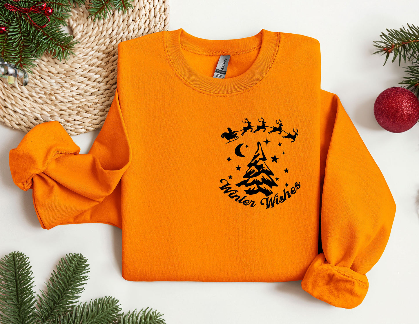 an orange sweatshirt with a christmas tree on it