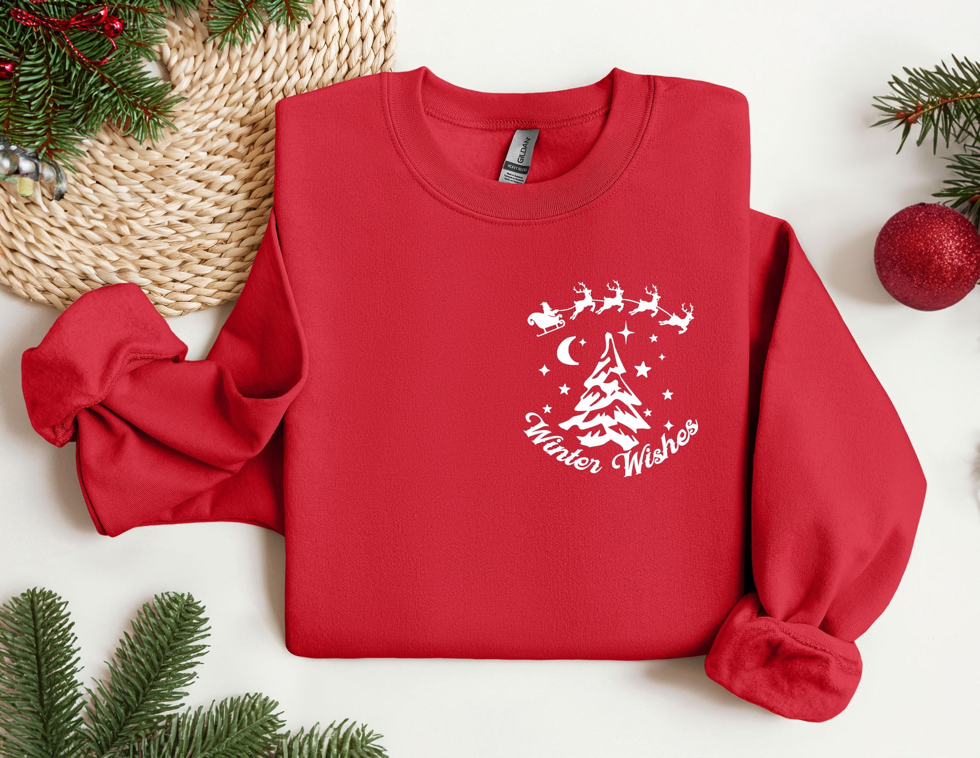 a red sweater with a christmas tree and santa&#39;s sleigh on it