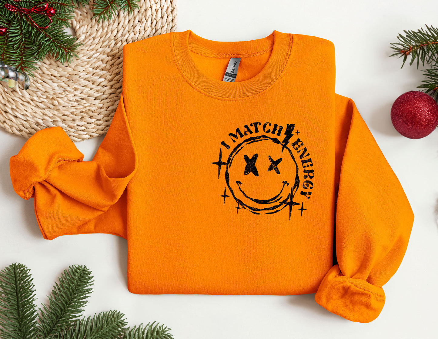 an orange sweatshirt with a smiley face on it