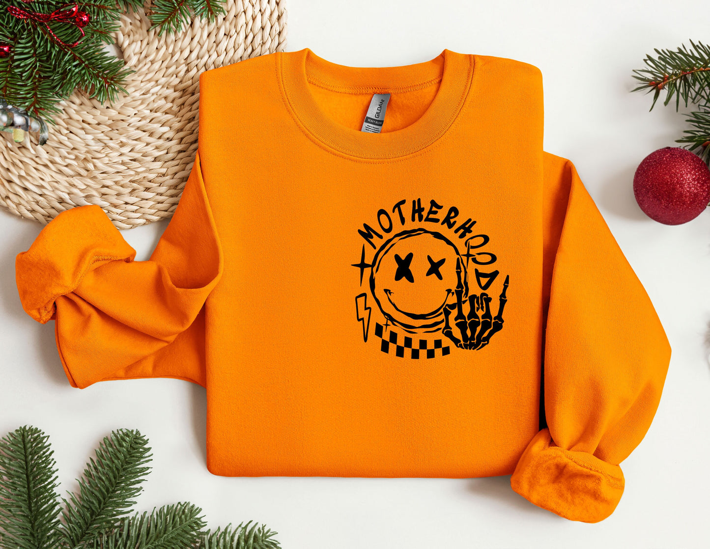 an orange sweatshirt with the words motherhood on it