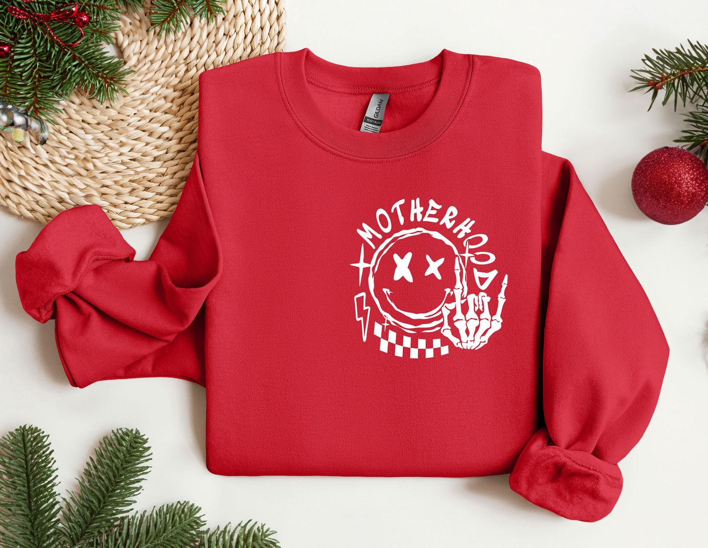 a red sweatshirt with the words motherhood printed on it